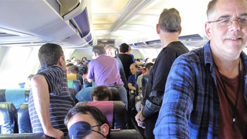 Plane Passengers In A Hurry Upon Landing To Get Their Items And Exiting