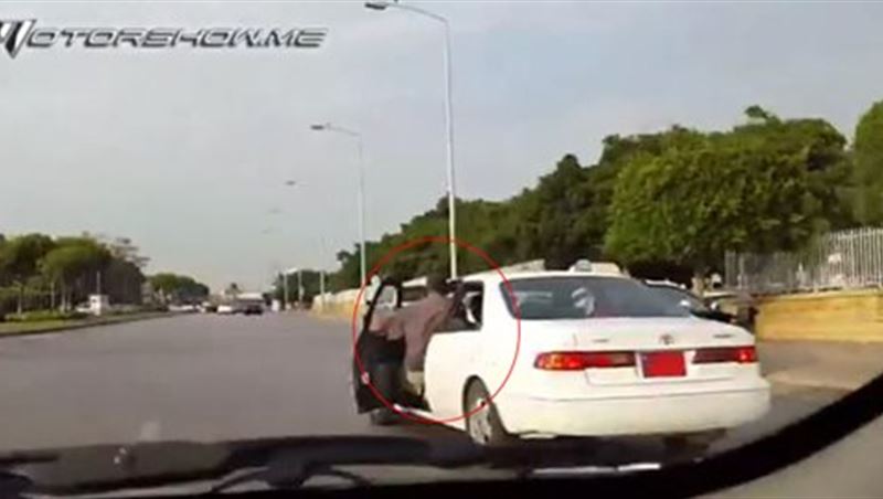 Man Sitting Outside His Car While Driving