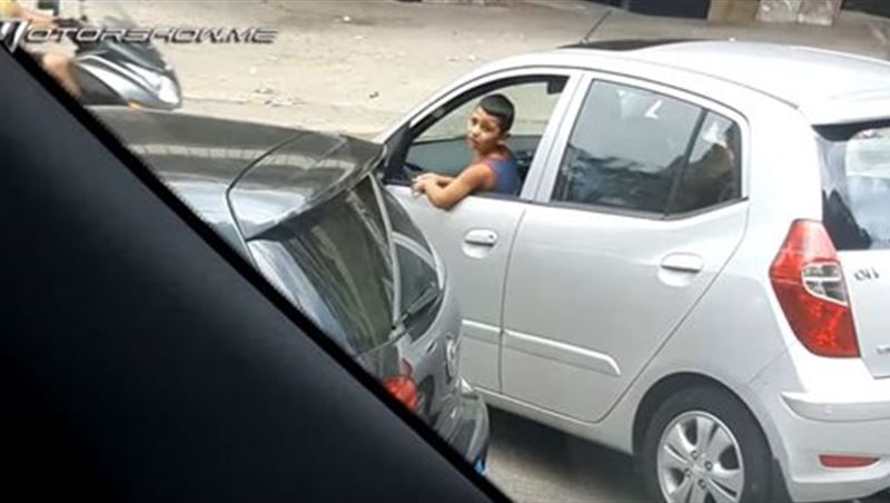 Child Sitting In Front And Outside the Car Window